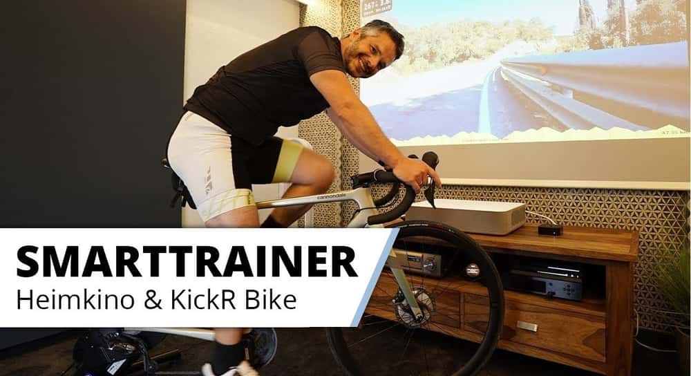 Das ultimative Indoor Cycling Erlebnis - im Heimkino. Kickr Bike Smart Trainer mit großem Bild.