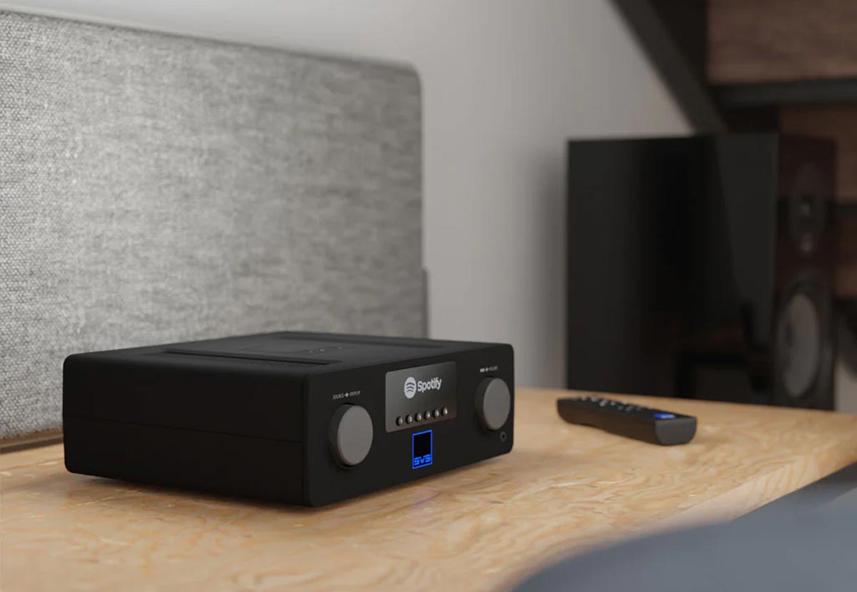 Audioverstärker mit Fernbedienung auf Tisch.