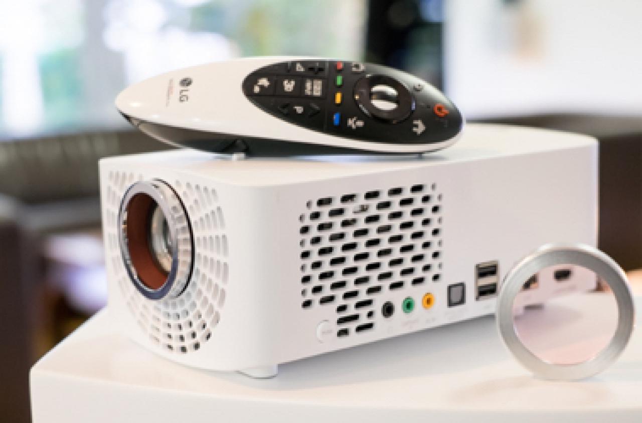 LG Largo ... klein aber oho! Weißer Projektor mit Fernbedienung auf Oberseite.